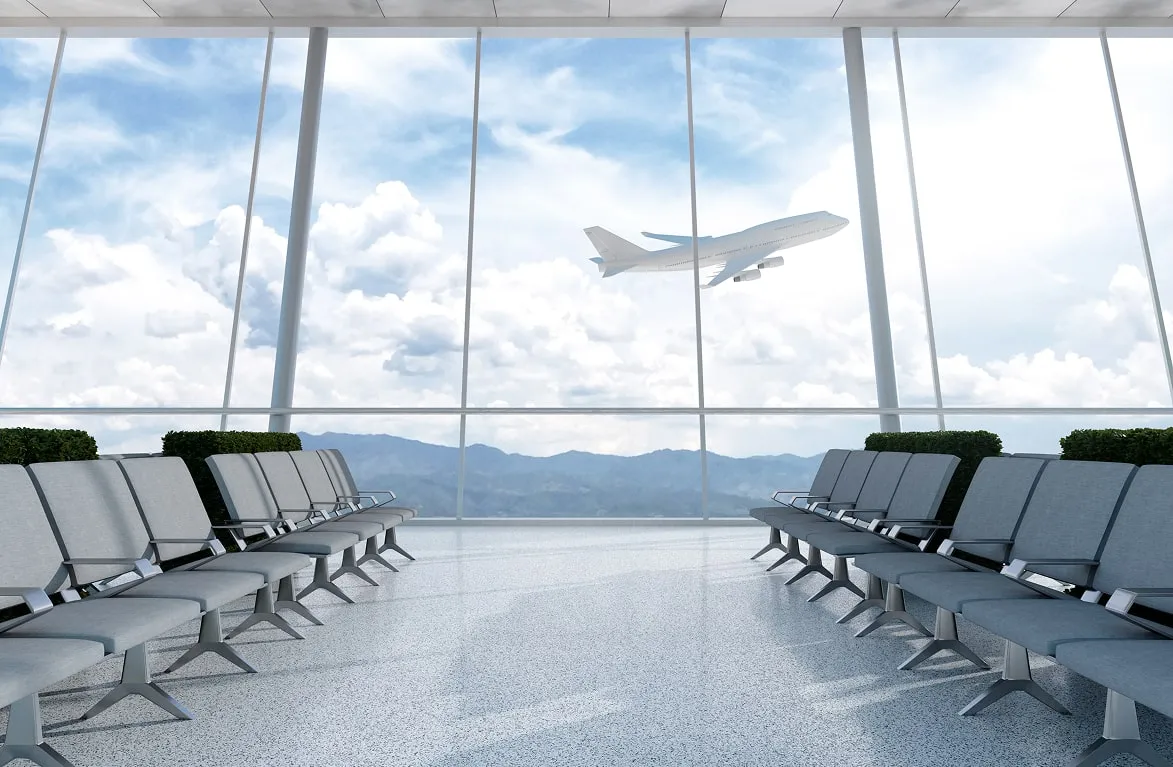 Airport terminal with seating and aircraft outside