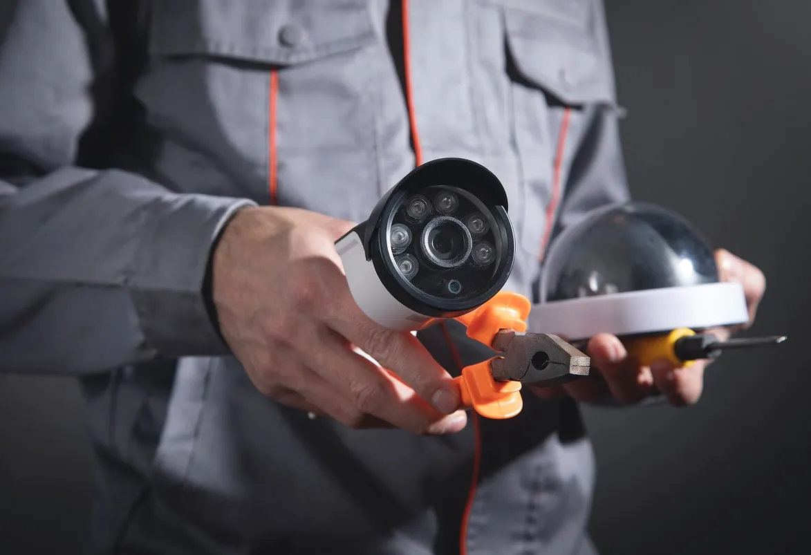 Technician holding a CCTV camera during installation