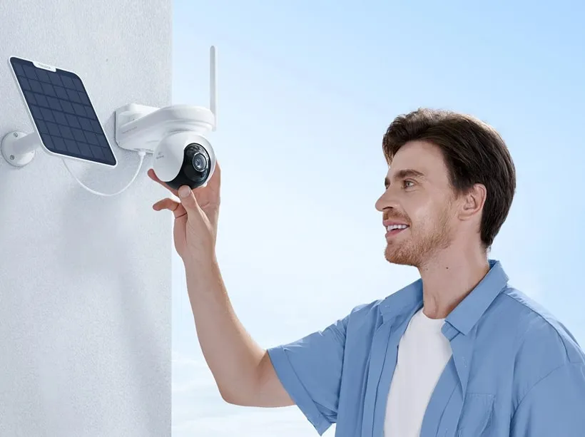 Technician installing a solar-powered security camera